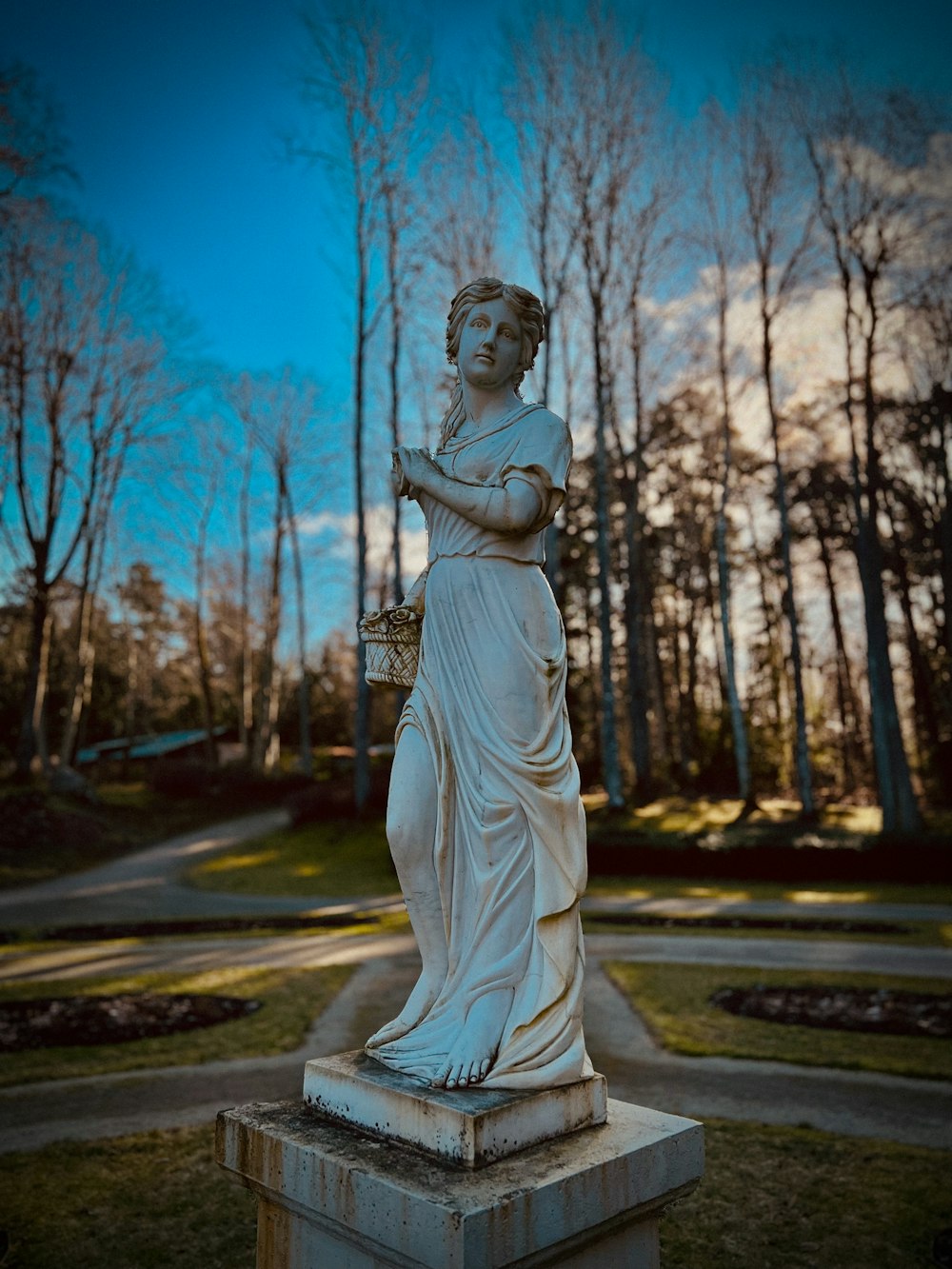 a statue of a woman holding a basket