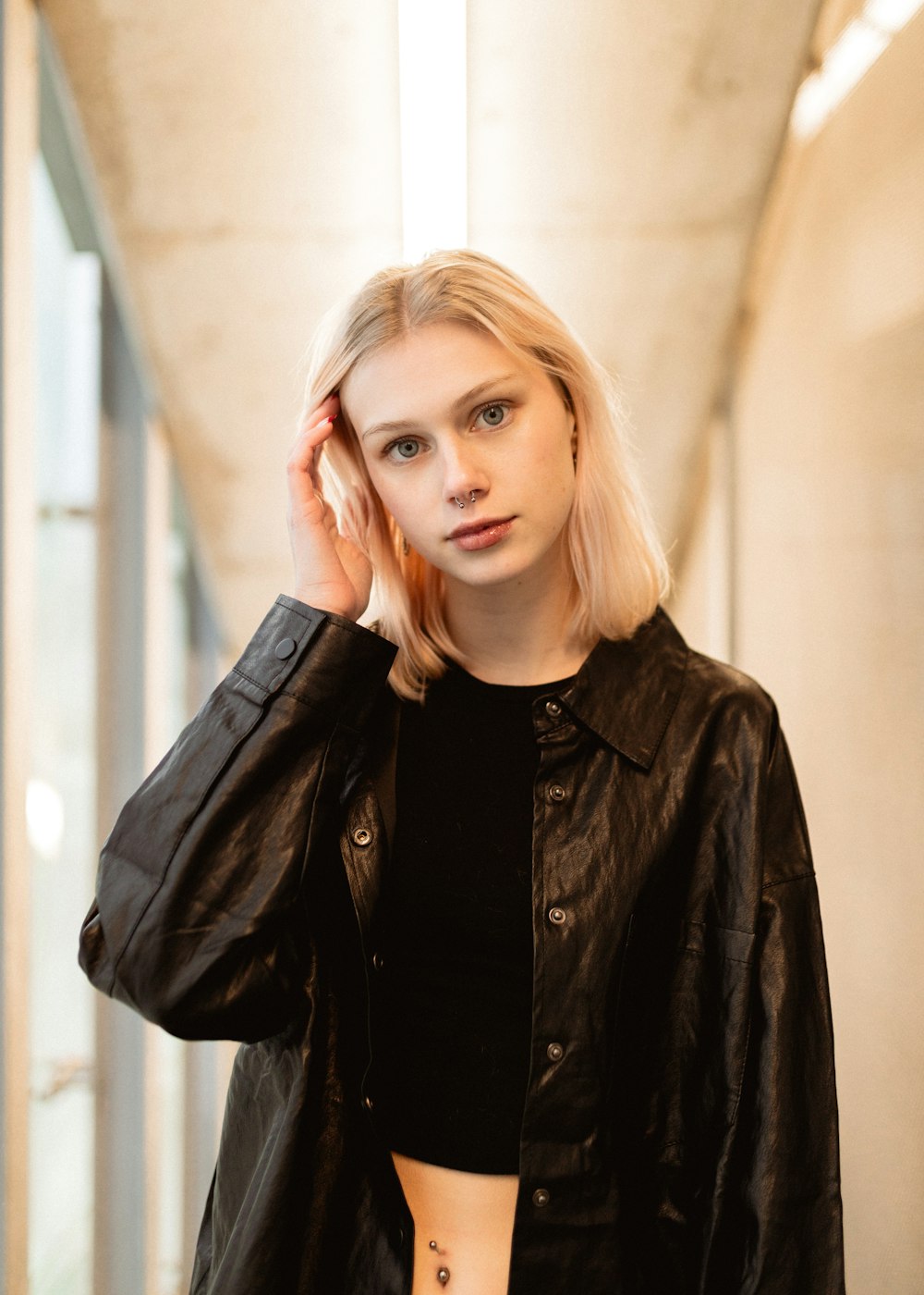 a woman with blonde hair wearing a black leather jacket