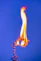 a lit candle with a blue sky in the background