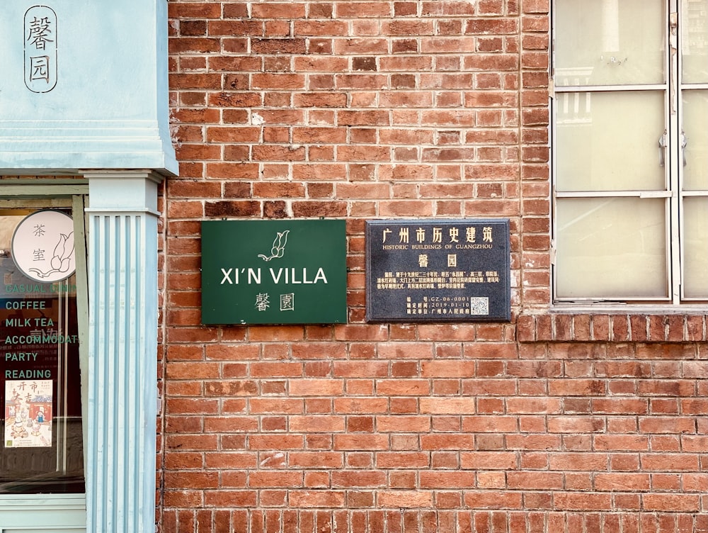 a brick building with a sign and a clock on it