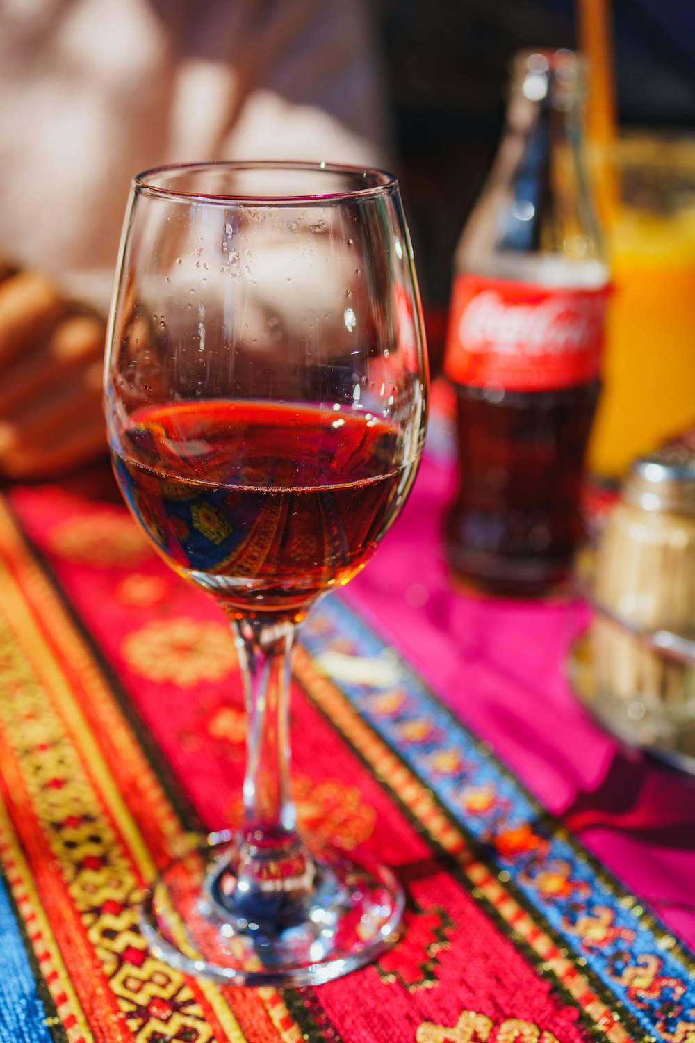 a glass of wine sitting on top of a table