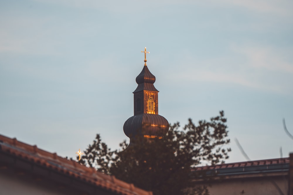 a building with a steeple and a cross on top