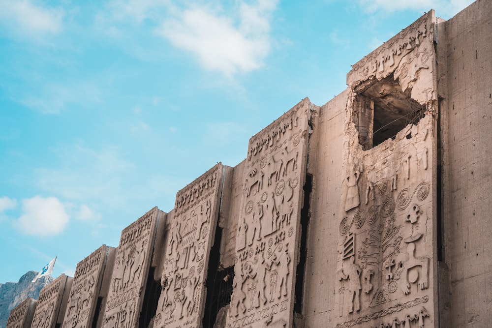 a close up of a wall with carvings on it