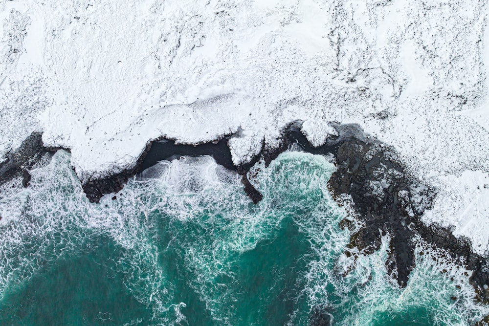 an aerial view of a body of water covered in snow