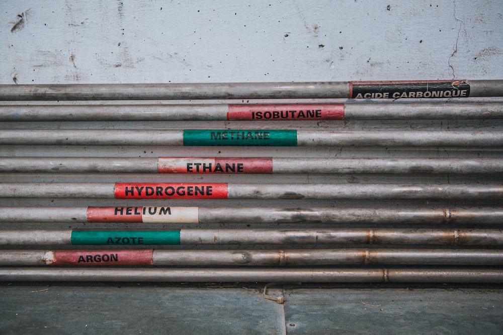 a bunch of metal pipes with red and green signs on them