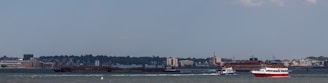 A panoramic view of a busy inland waterway with multiple autonomous vessels in operation.