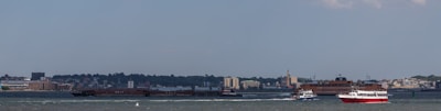 A panoramic view of a busy inland waterway with multiple autonomous vessels in operation.