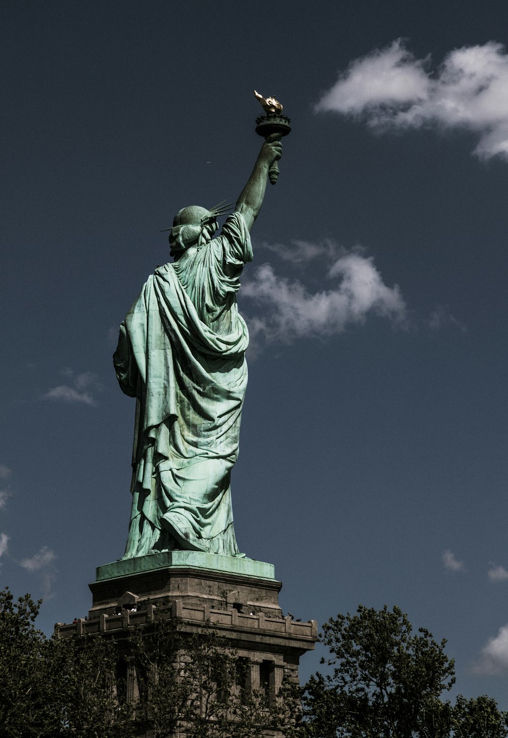 the statue of liberty is shown against a blue sky