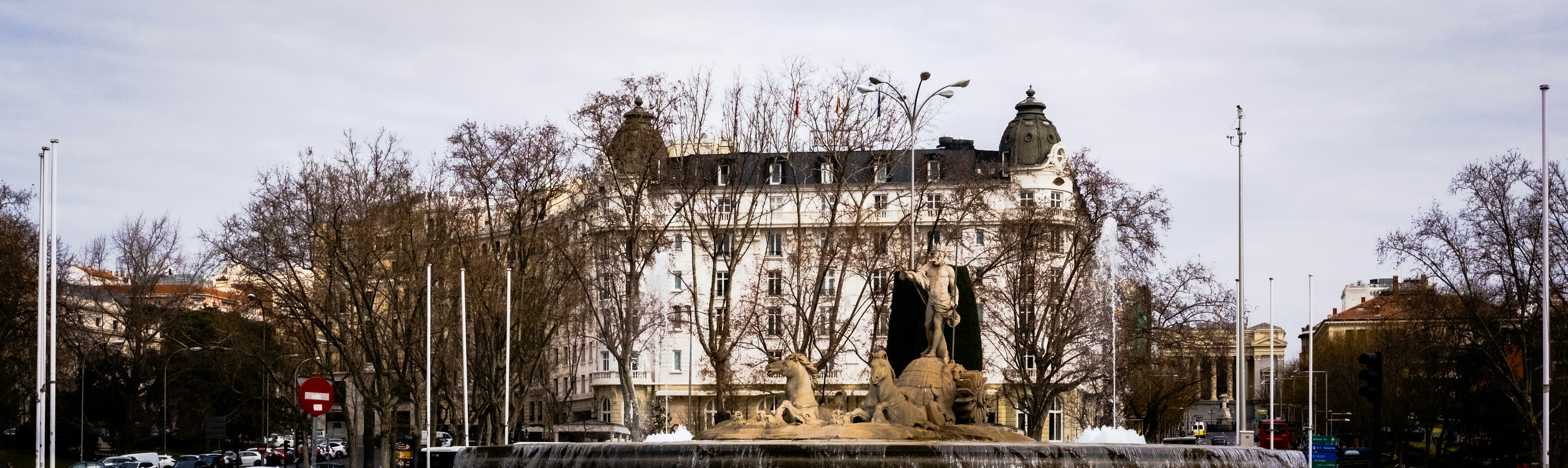 a large building with a fountain in front of it