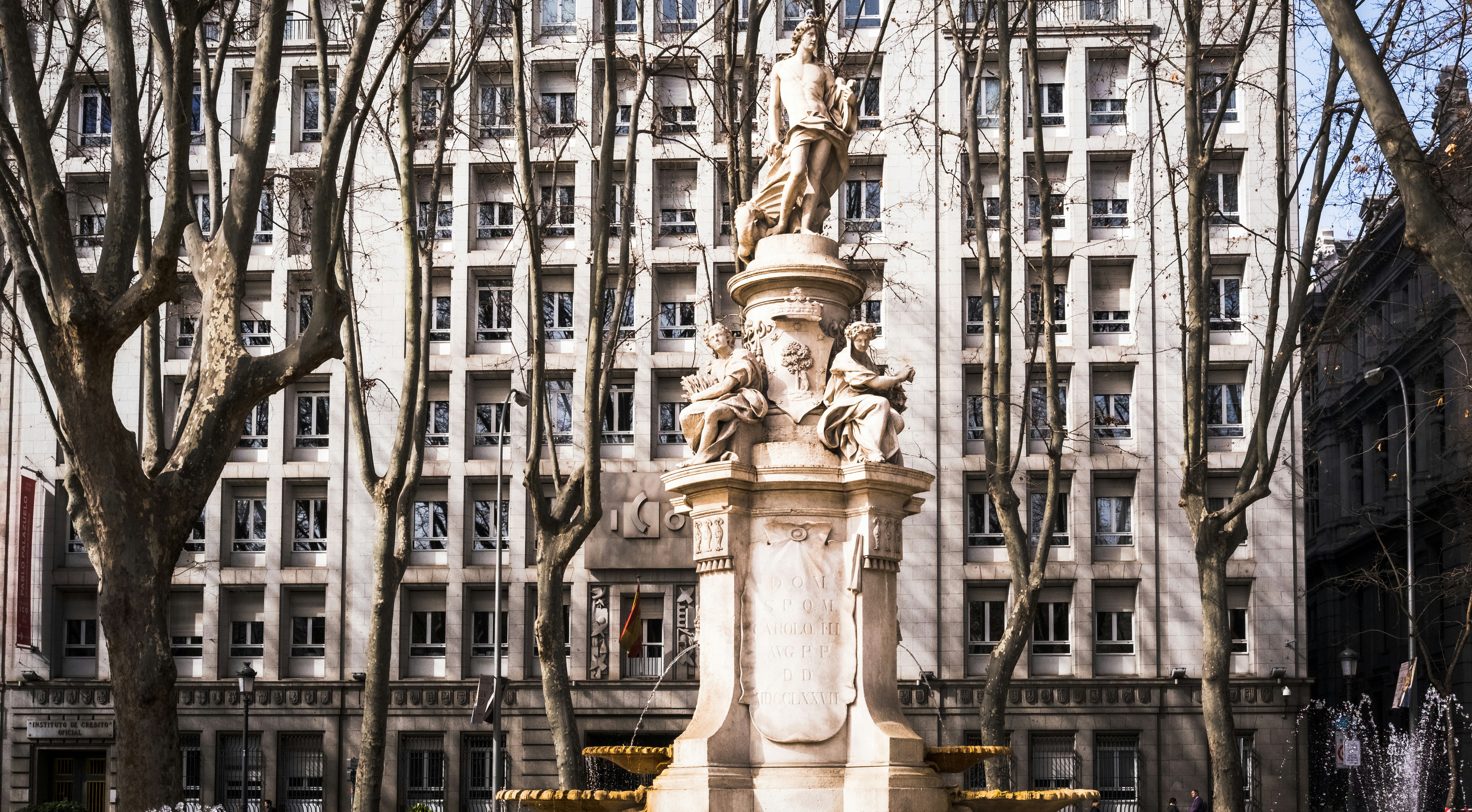 a statue in front of a tall building