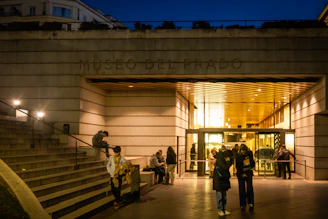 The iconic Prado Museum facade with visitors admiring the art inside.