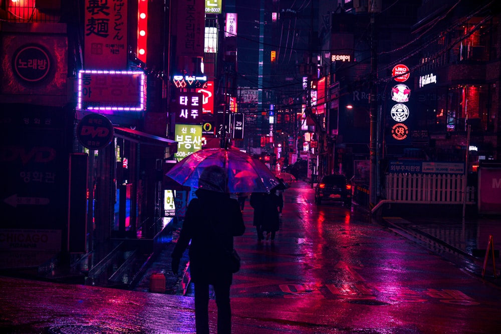 a person walking down a street holding an umbrella