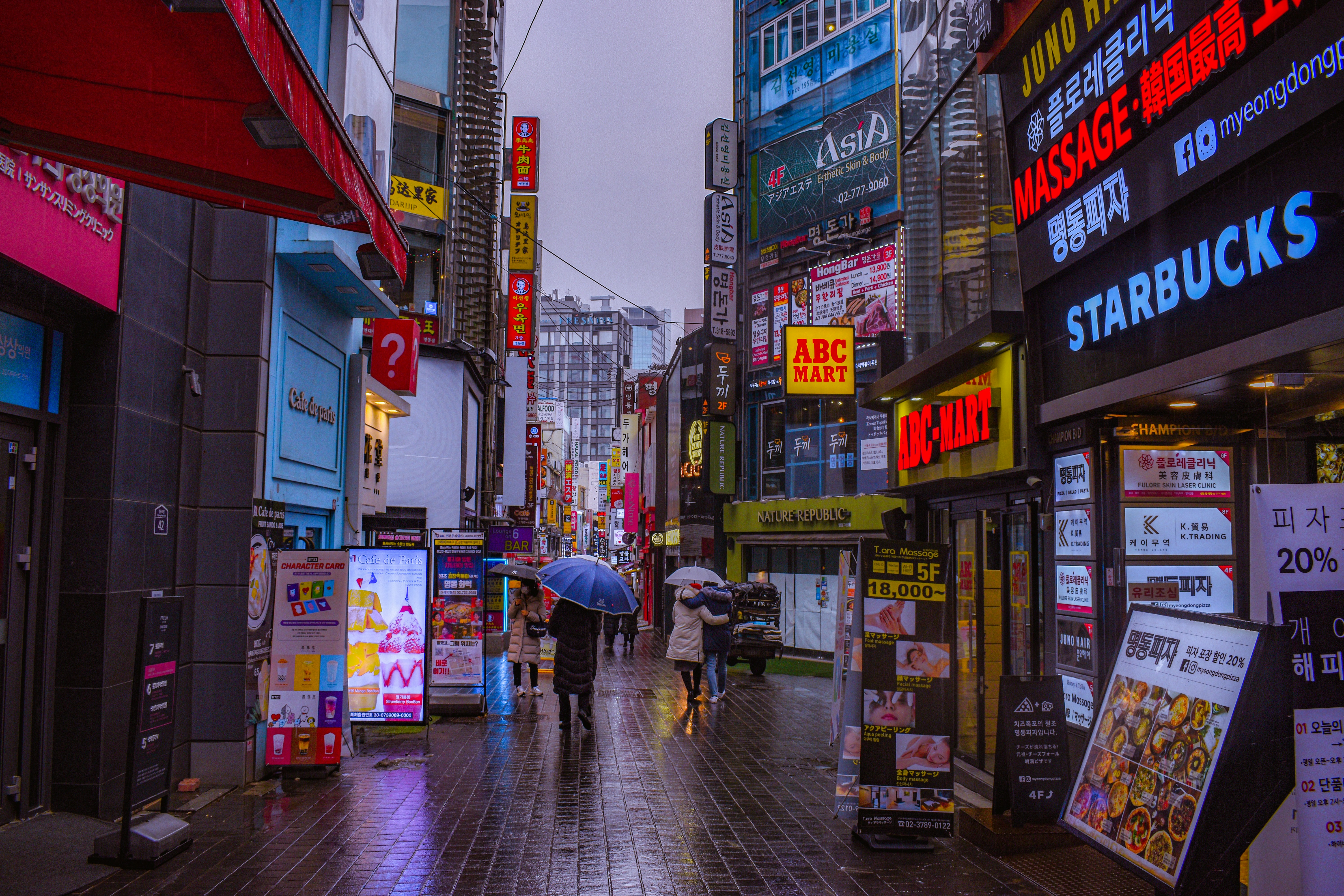 a person walking down a street holding an umbrella