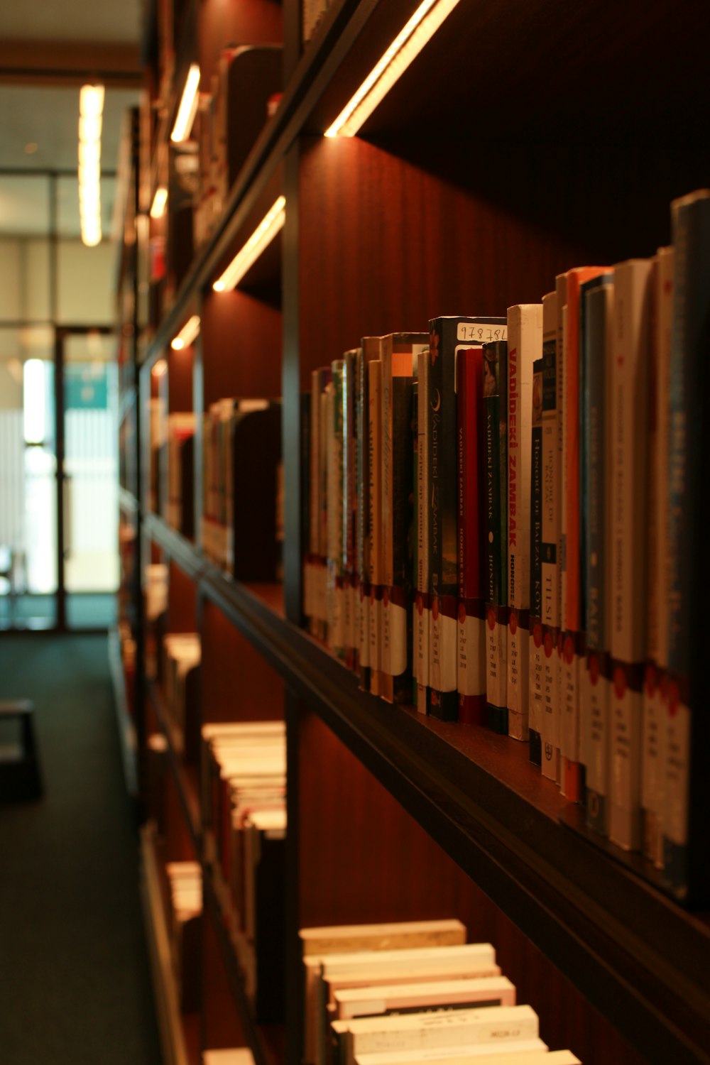 a row of books on a shelf in a library