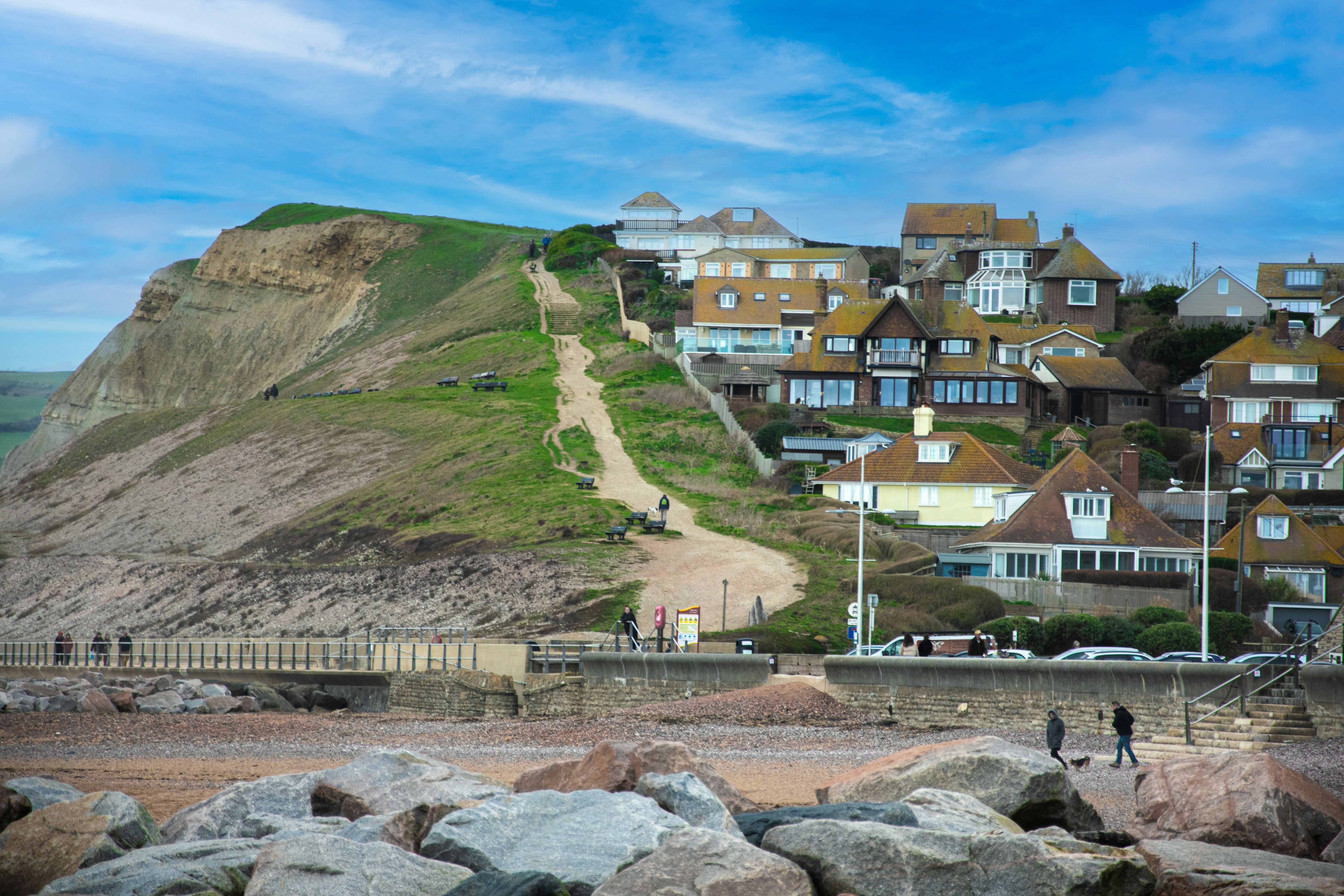 a group of people standing on top of a sandy beach