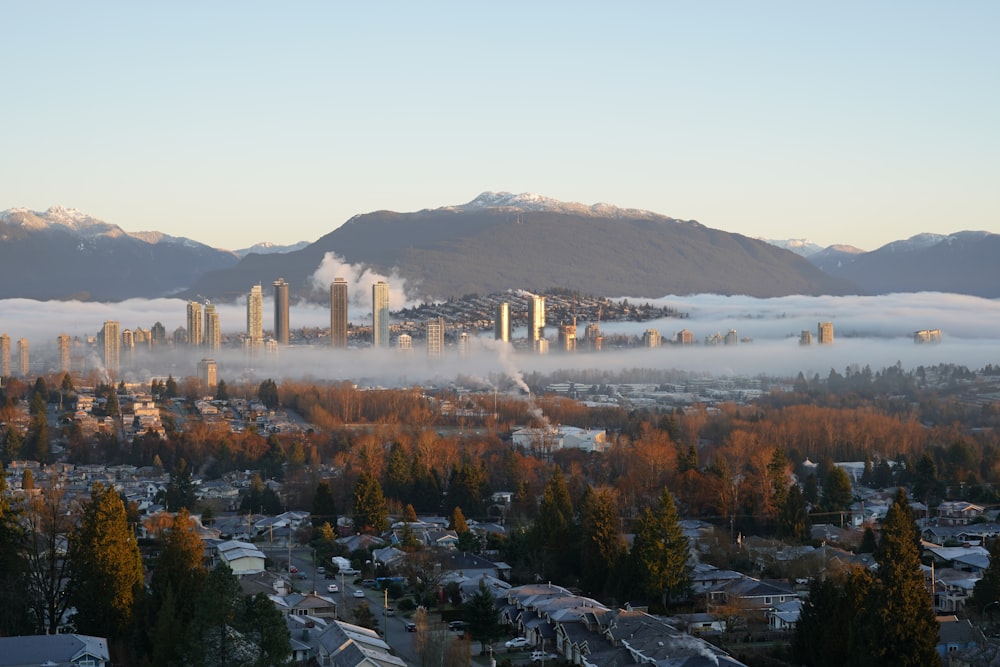 a view of a city in the distance with mountains in the background