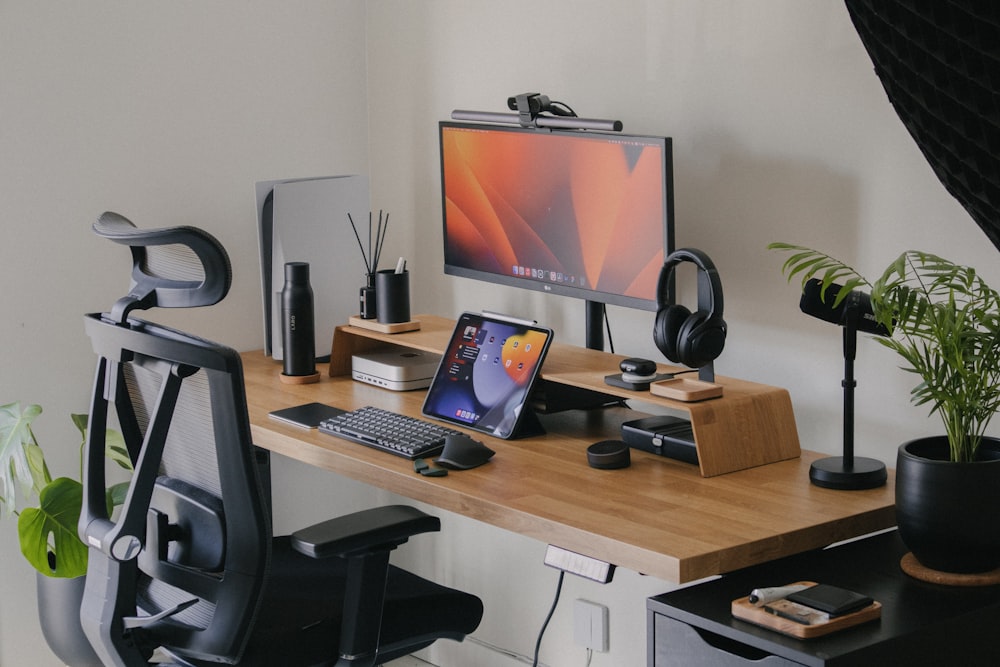 a wooden desk topped with a computer monitor and keyboard