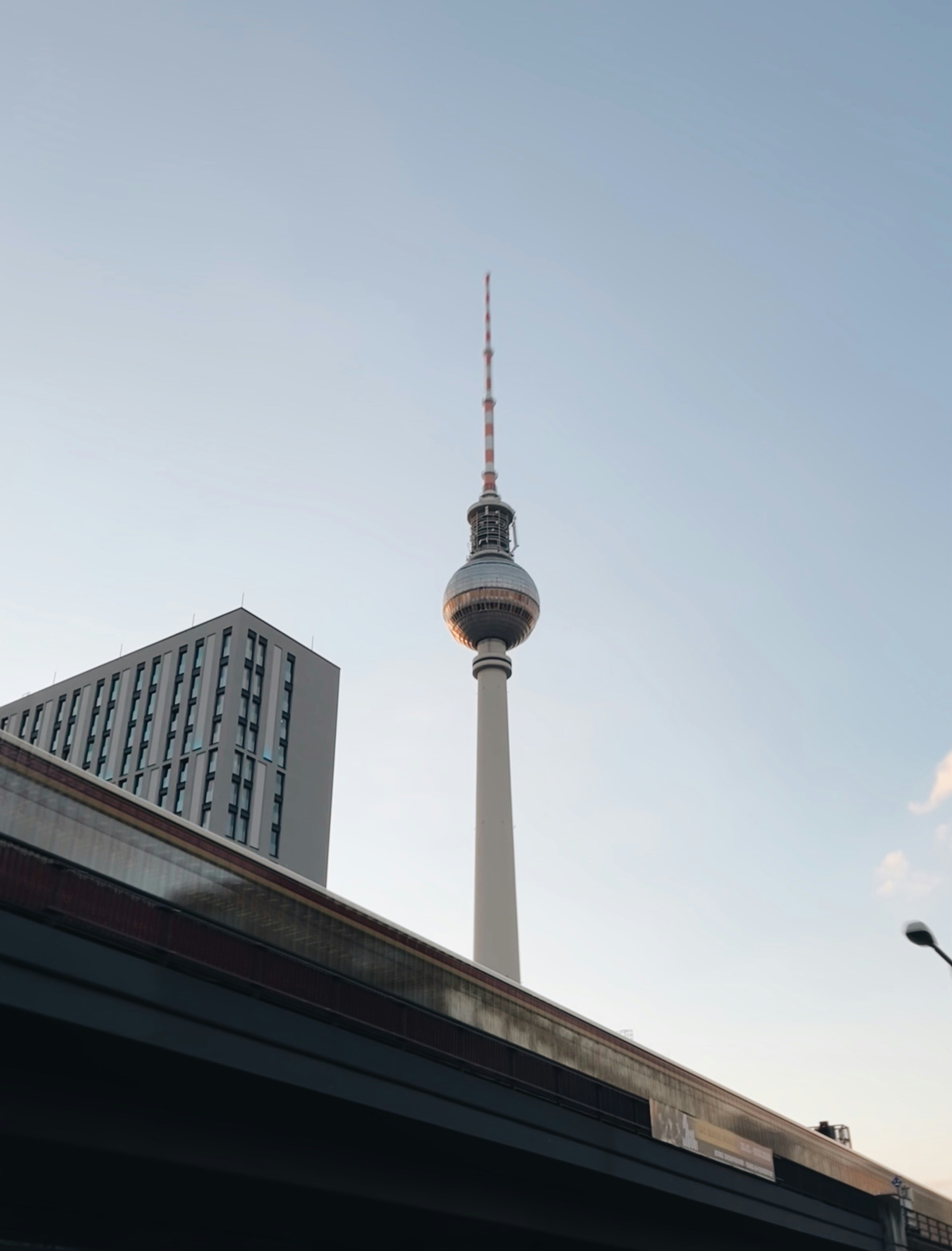 A very tall tower towering over a city photo – Free Architecture Image ...