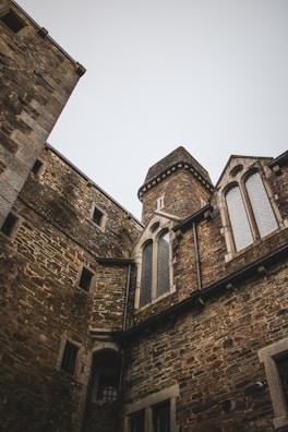 Architectural details of a medieval city-state’s fortified walls under a moody sky.