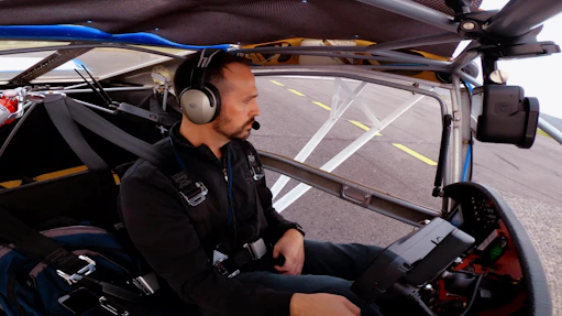 Technician installing electronic components inside an aircraft cockpit.