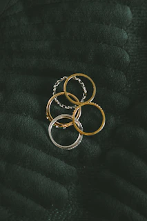 a bunch of rings sitting on top of a blanket