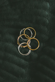 a bunch of rings sitting on top of a blanket