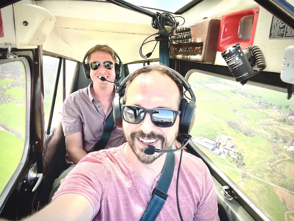 a man and a woman are sitting in a helicopter