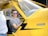a man sitting in the cockpit of a yellow plane