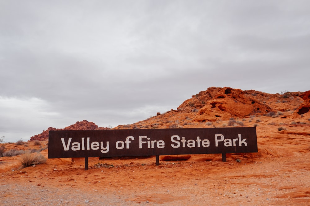 a sign that is in the middle of a dirt field