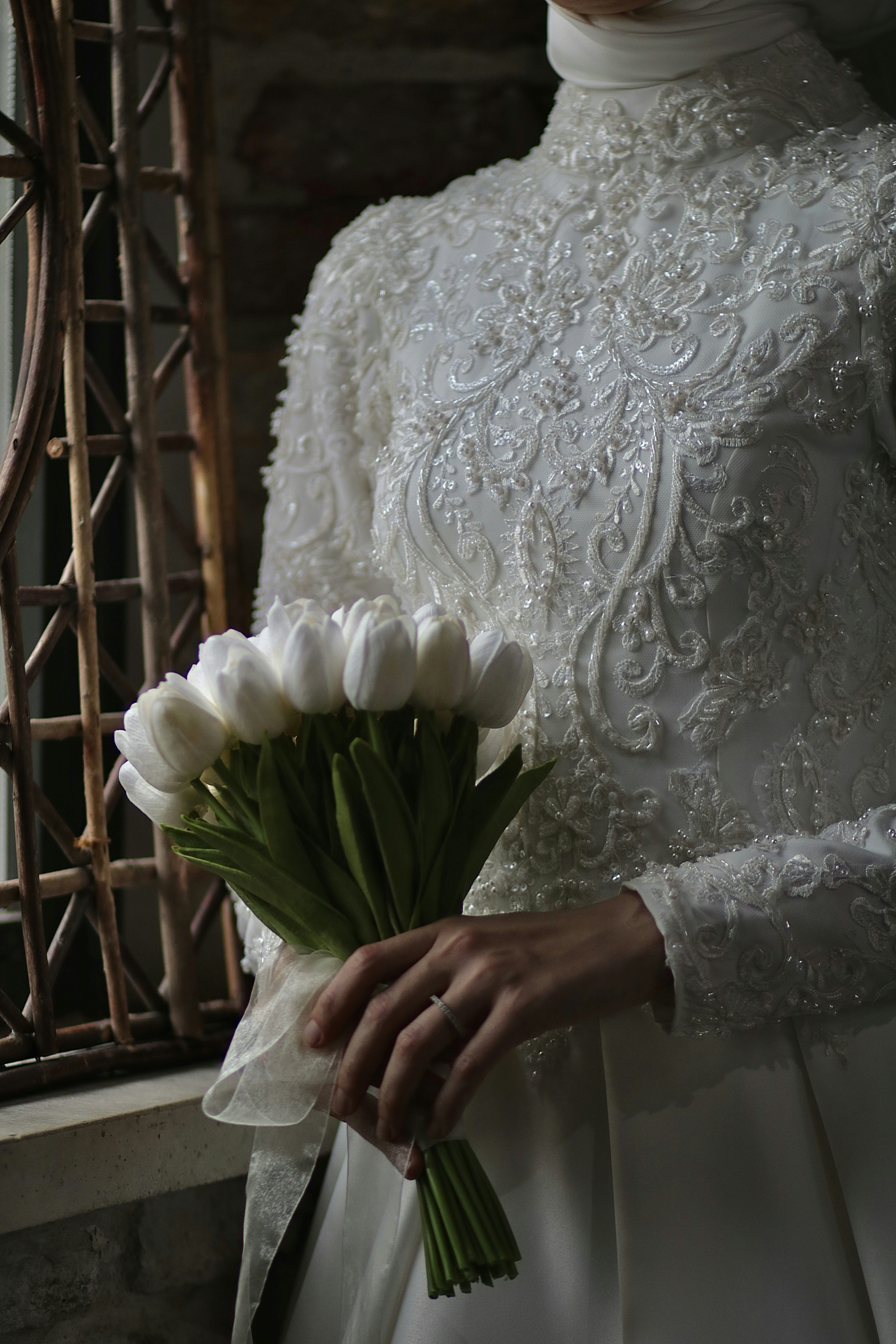 a woman in a white dress holding a bouquet of flowers