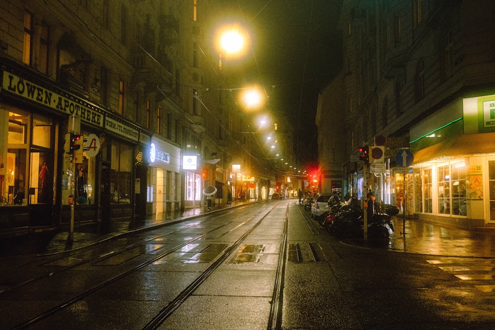 a city street at night with traffic lights