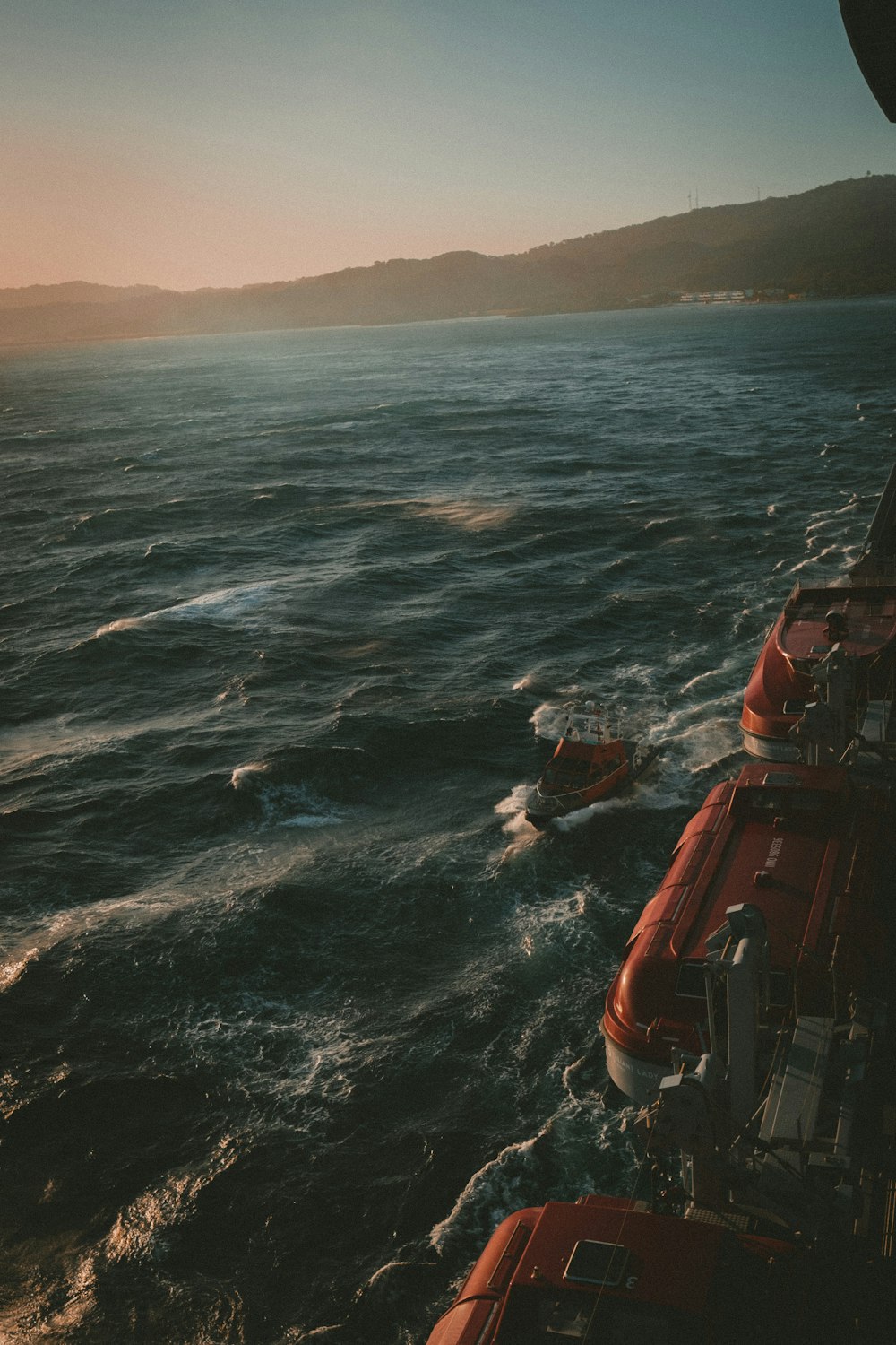 a red boat in the middle of a body of water