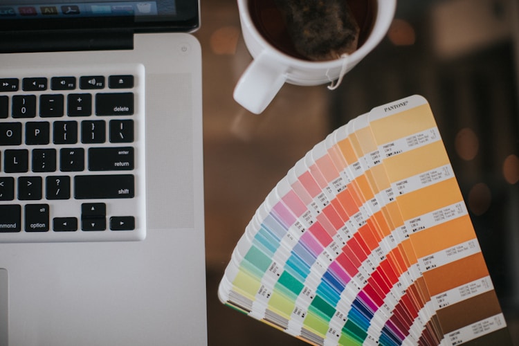 Color palette and laptop used to define brand rules in a long-form YouTube client workflow