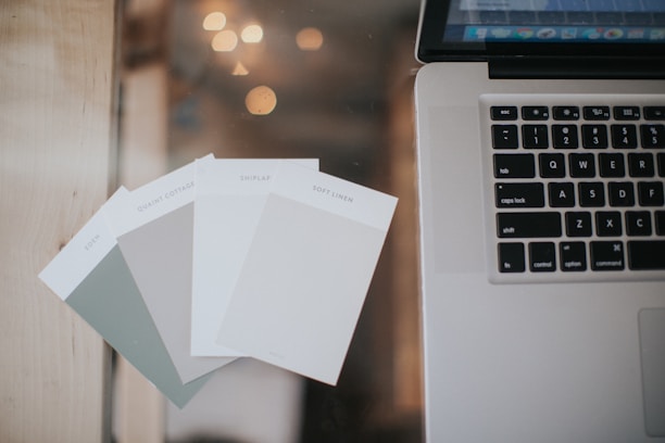 a laptop computer sitting on top of a wooden table