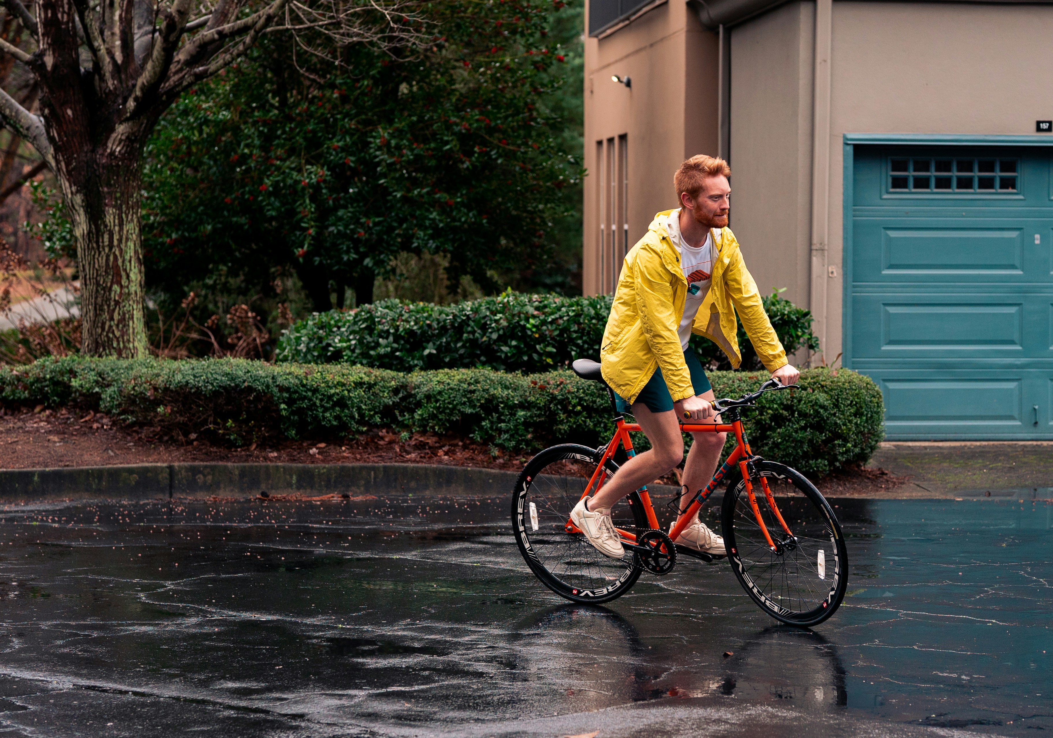 a man riding a bike in the rain