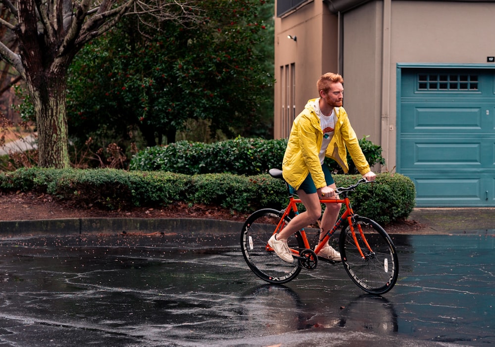 a man riding a bike in the rain