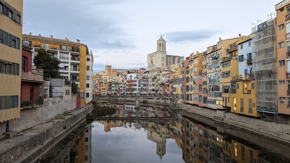 a river running through a city next to tall buildings