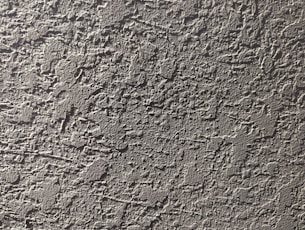 a close up of a cement wall with cracks