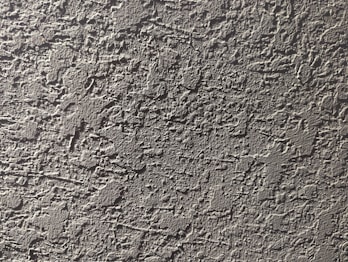 a close up of a cement wall with cracks