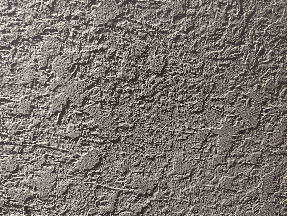 a close up of a cement wall with cracks