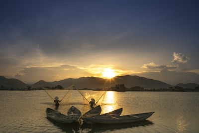 A group of fishermen enjoying a sunny day, casting lines into a peaceful lake.