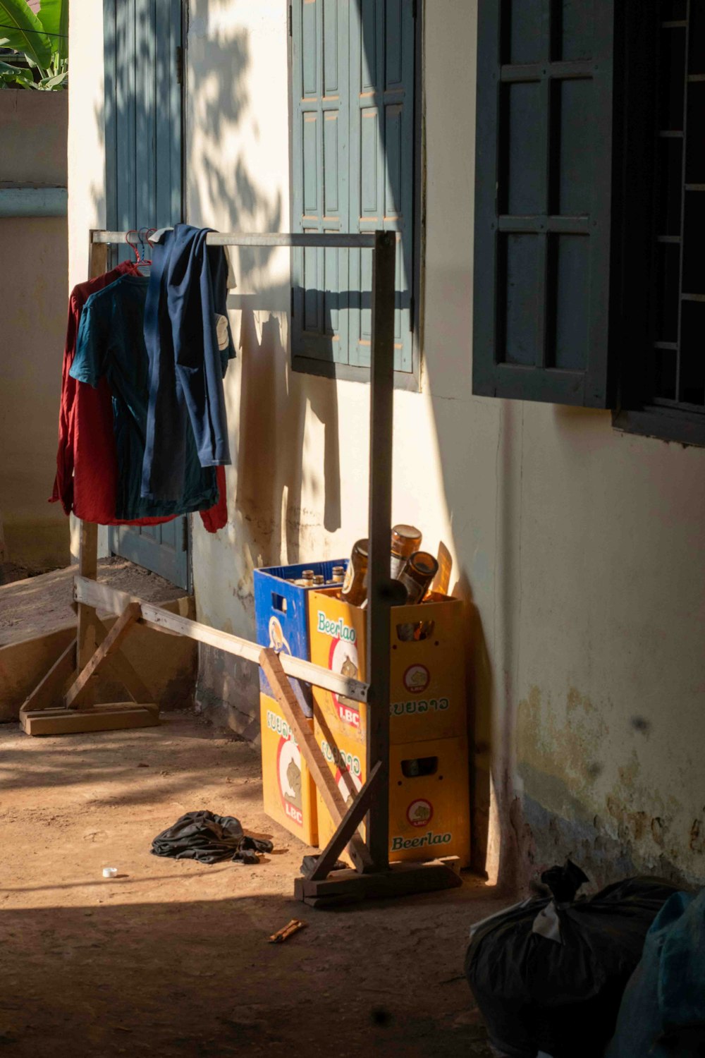 a blue jacket hanging on a clothes line outside of a building