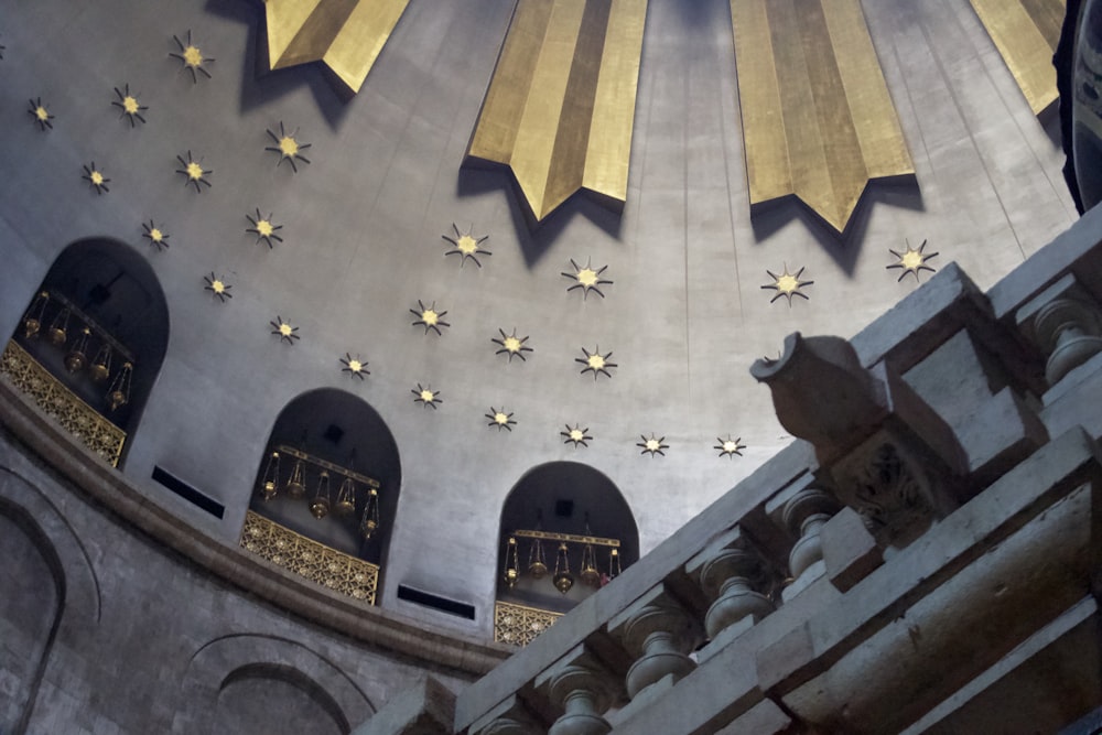 the ceiling of a building with gold stars on it