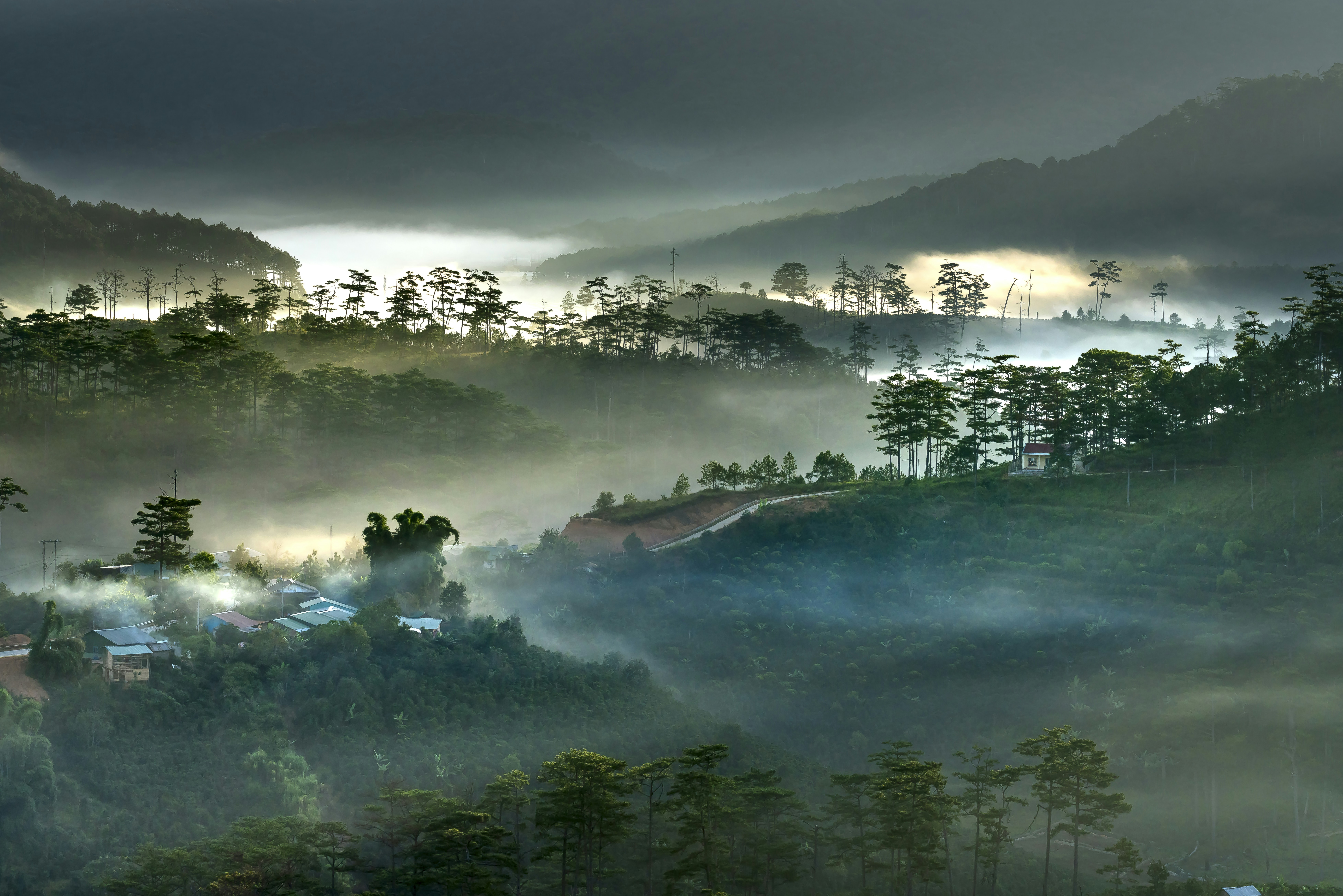 Foggy mountain valley with distant houses
