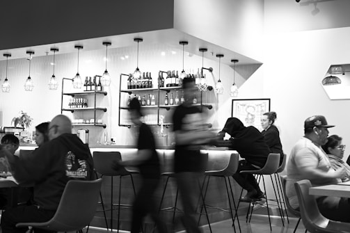 a group of people sitting at a table in a restaurant