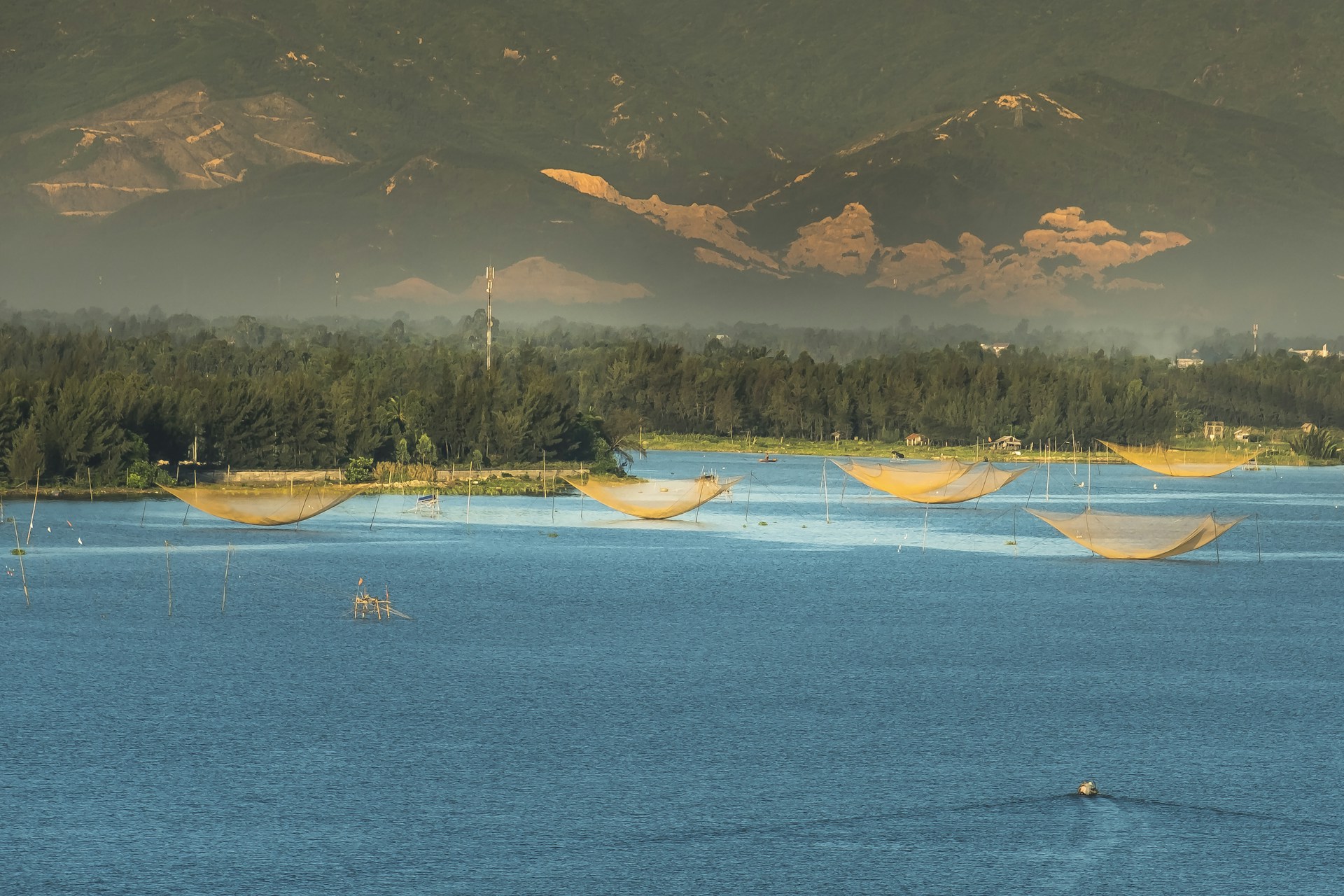 An engaging image of a fishing scene at dawn, with nets and boats ready for a day’s catch against a calm water backdrop.