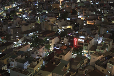 High-contrast photo of a street evangelism event at night with neon city lights.