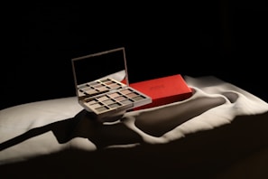 Soft-focus scene of a makeup brush sweeping over a palette with earthy tones.