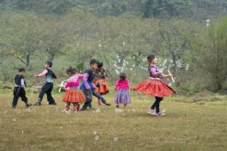 a group of children playing with bubbles in a field