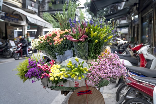 a bunch of flowers that are sitting on a bike